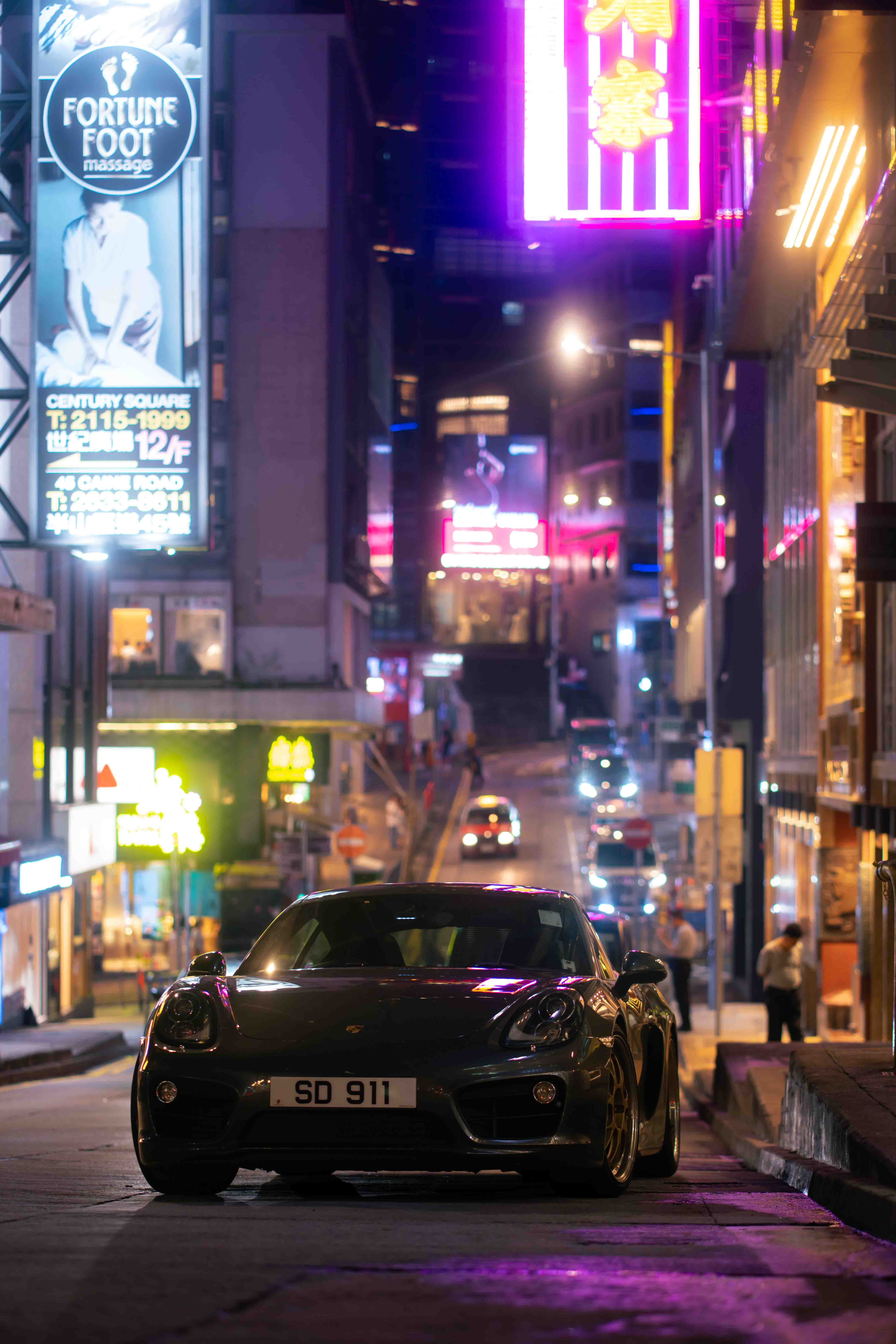Porsche 911 under the bright neon lights