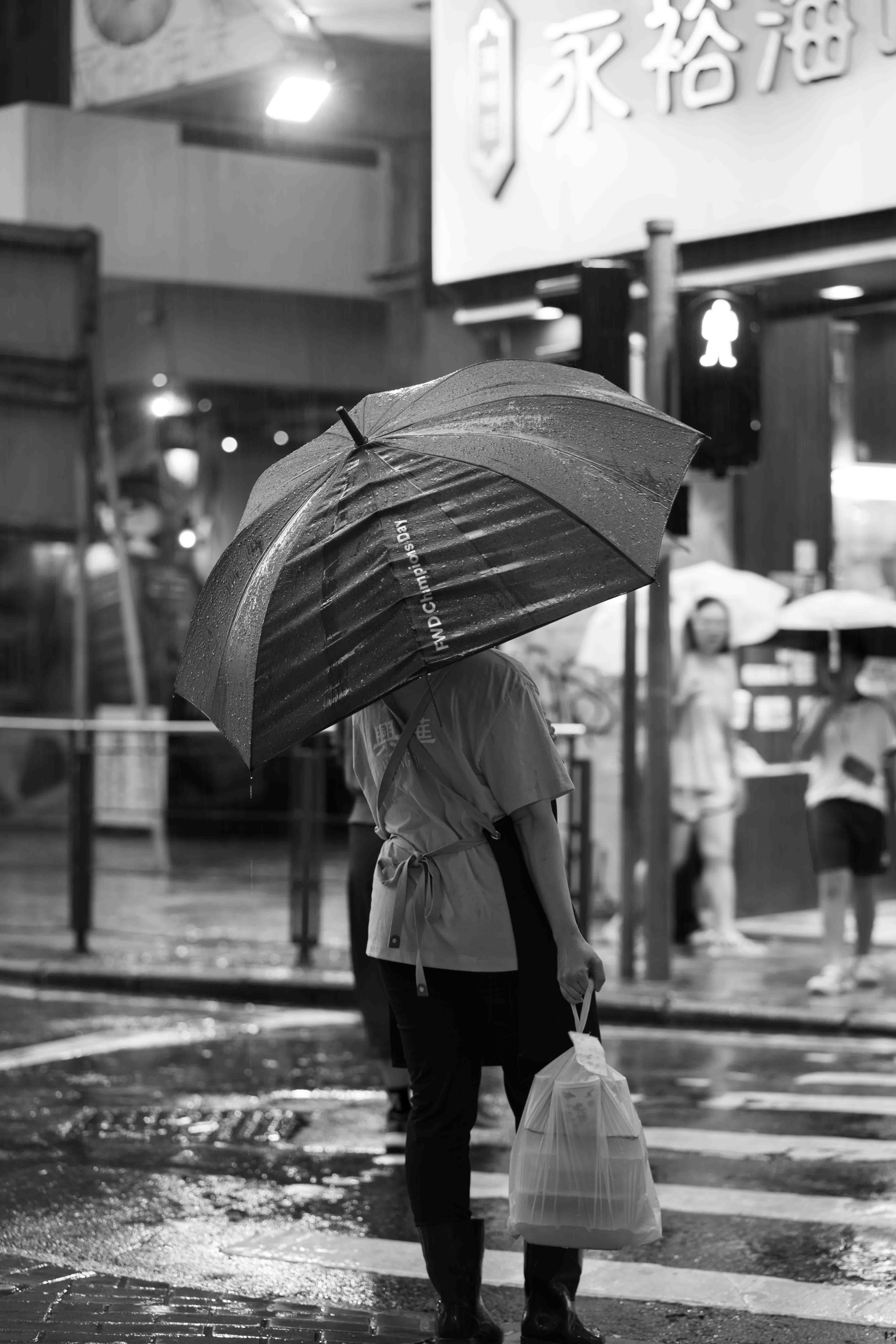 Umbrella in one hand, food in another
